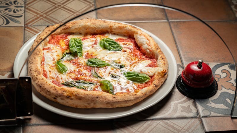 Margherita pizza with fresh basil and mozzarella